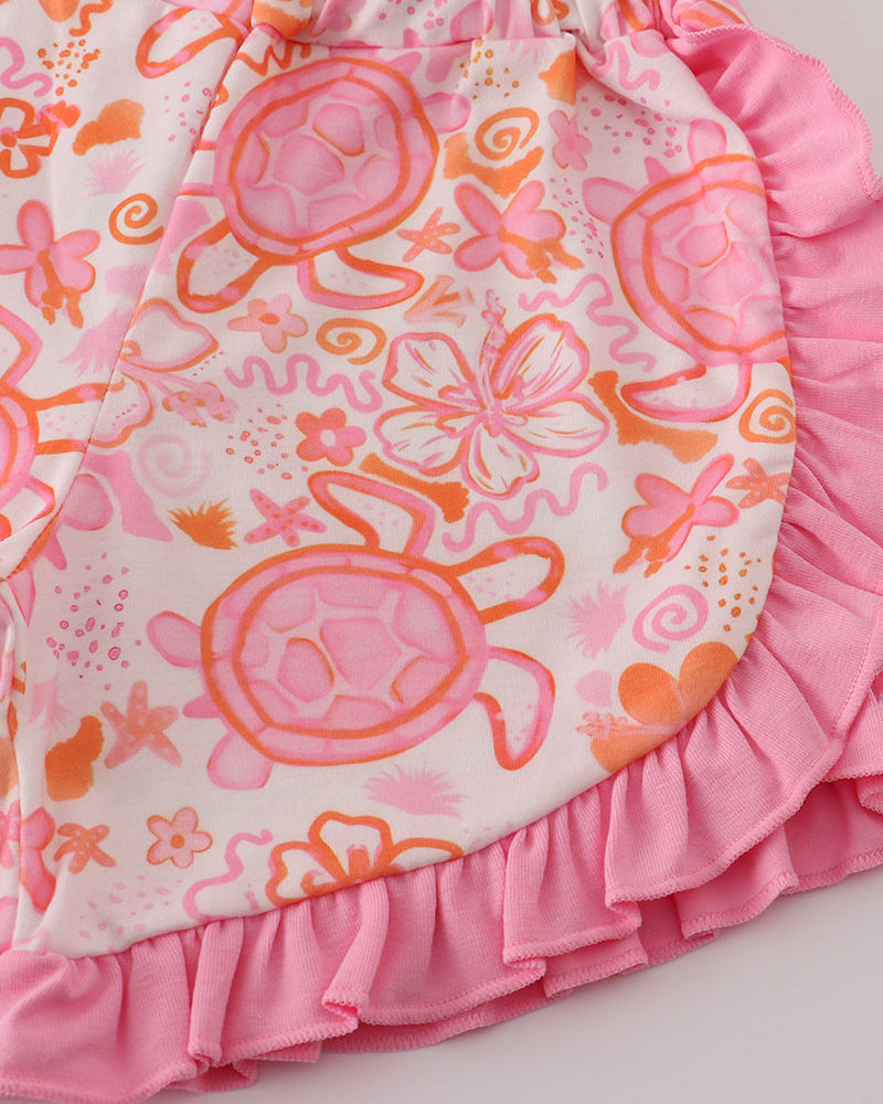 Pink and orange shorts with turtle design on a white background
