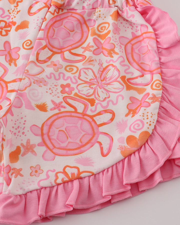 Pink and orange shorts with turtle design on a white background