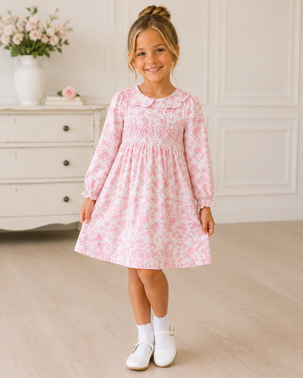 Pink floral smocked dress with long sleeves and gathered skirt