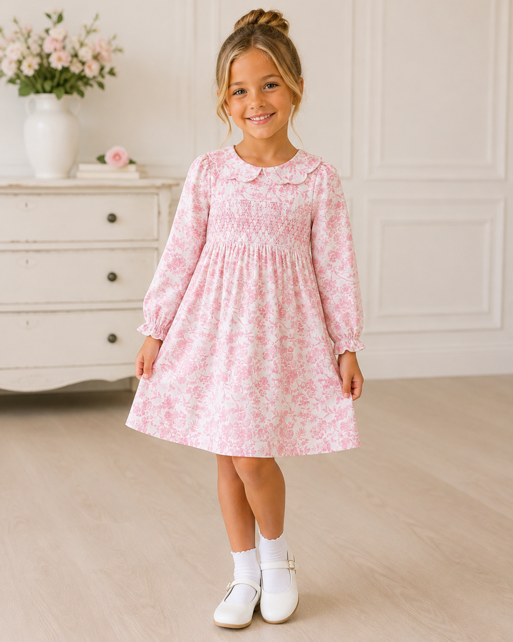 Pink floral smocked dress with long sleeves and gathered skirt
