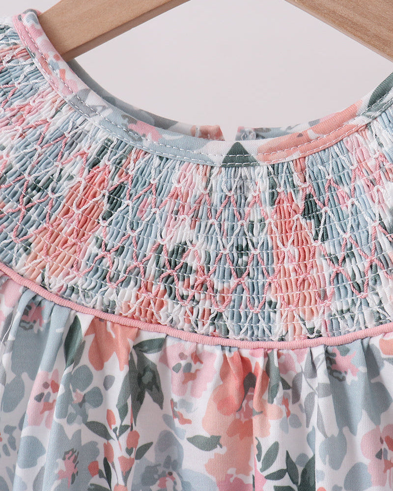 Floral dress with smocked neckline on a hanger
