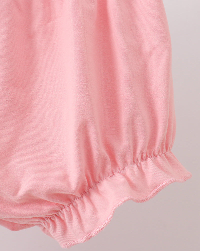 Pink baby bloomers on a light gray background