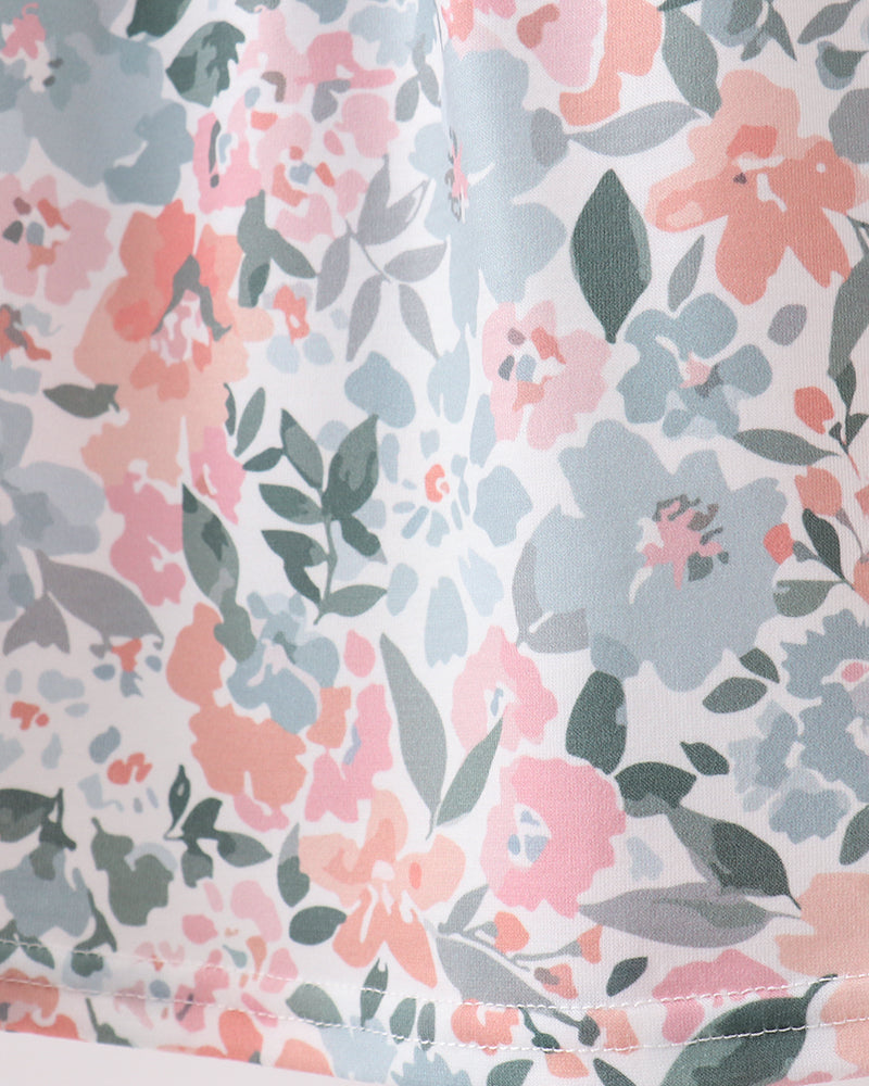Floral patterned fabric with pink, blue, and green flowers on a light background