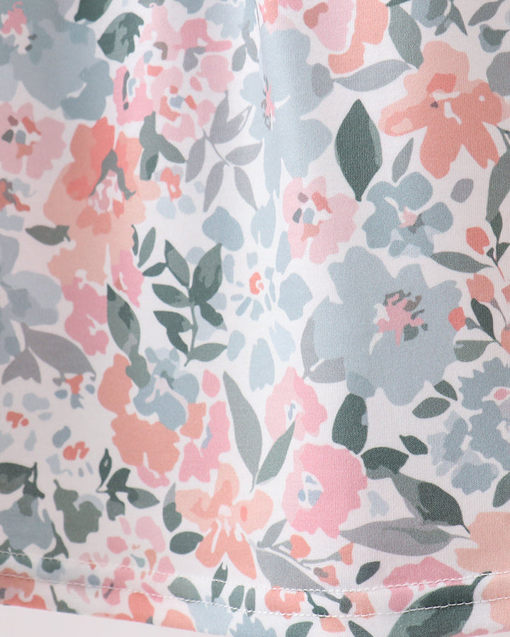 Floral patterned fabric with pink, blue, and green flowers on a light background