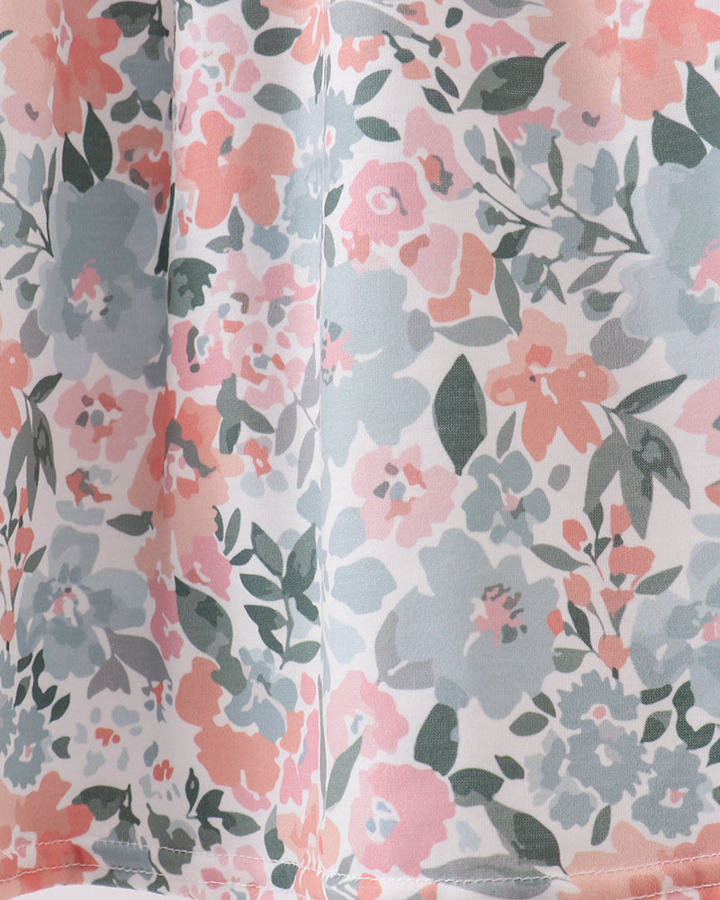 Floral patterned fabric with pink, gray, and green flowers on a white background