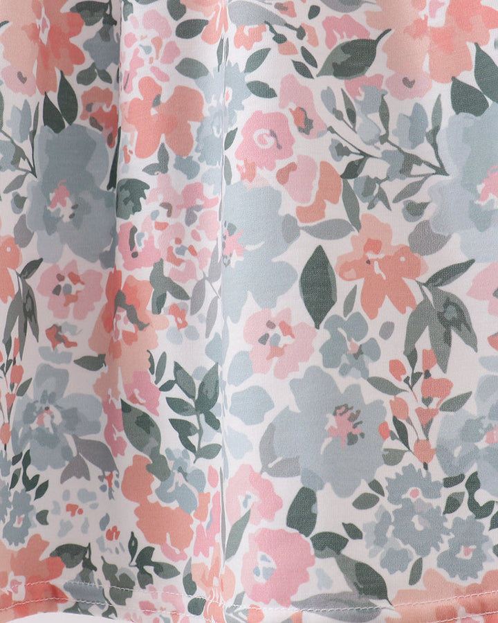 Floral patterned fabric with pink, gray, and green flowers on a white background
