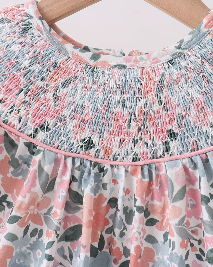 Floral dress with smocked neckline on a hanger