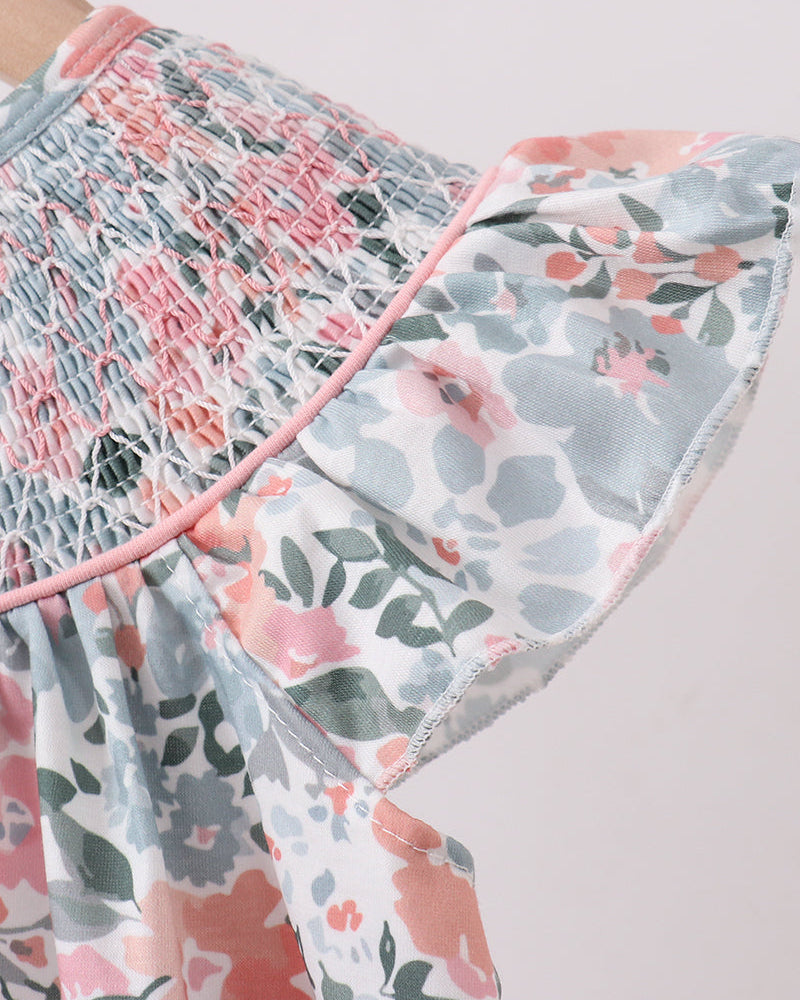 Floral patterned fabric with pink and green accents on a white background