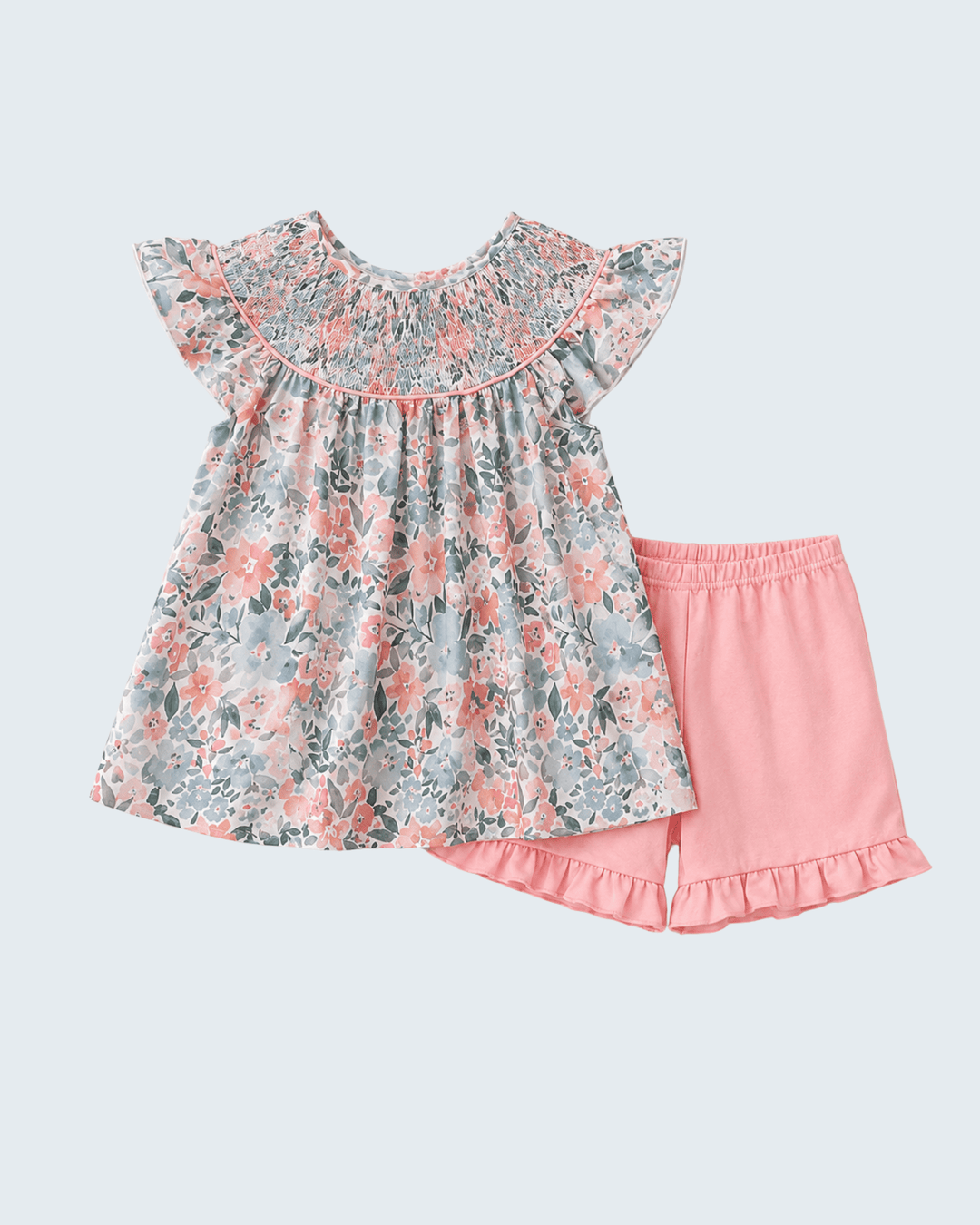 Floral top and pink shorts set on a light gray background
