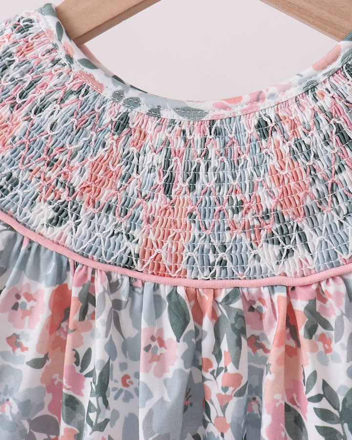 Floral dress with smocked neckline on a hanger