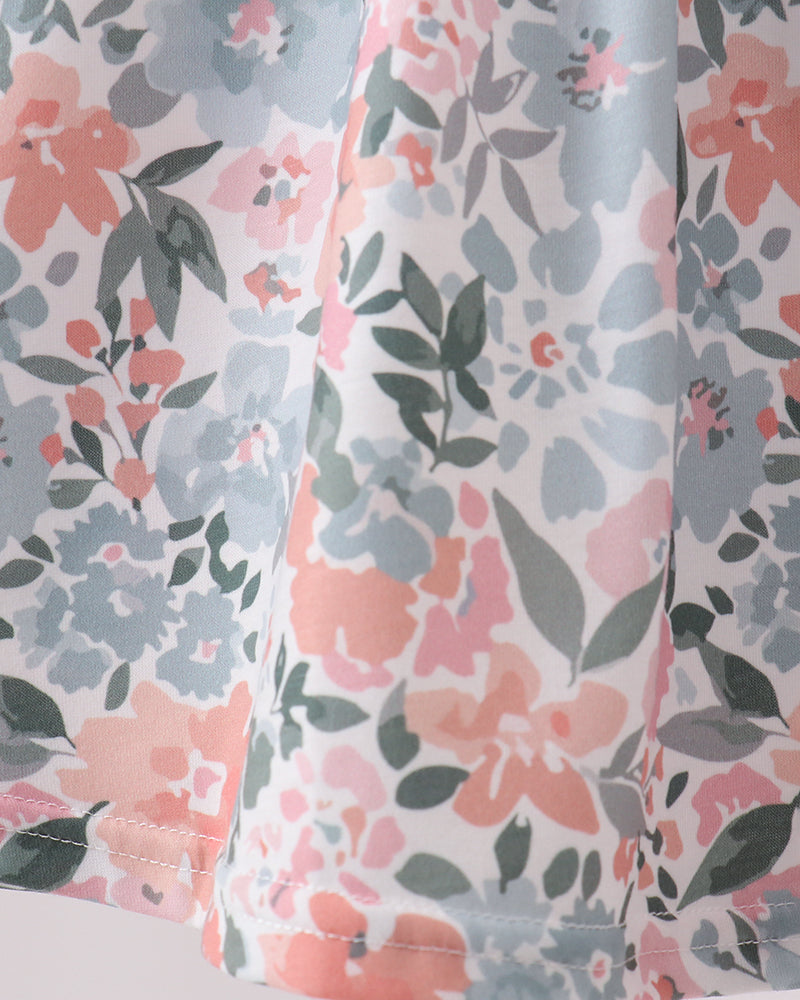 Floral patterned fabric with pink and gray flowers on a white background