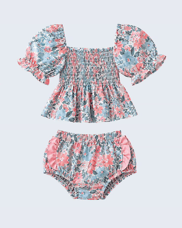 Floral baby swim set with top and bloomers on a light gray background