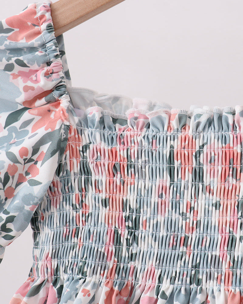 Floral swim top with smocked waistband on a white background