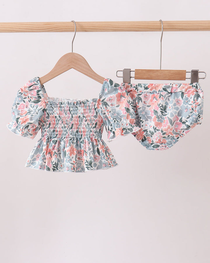 Floral swim set on hangers against a light background