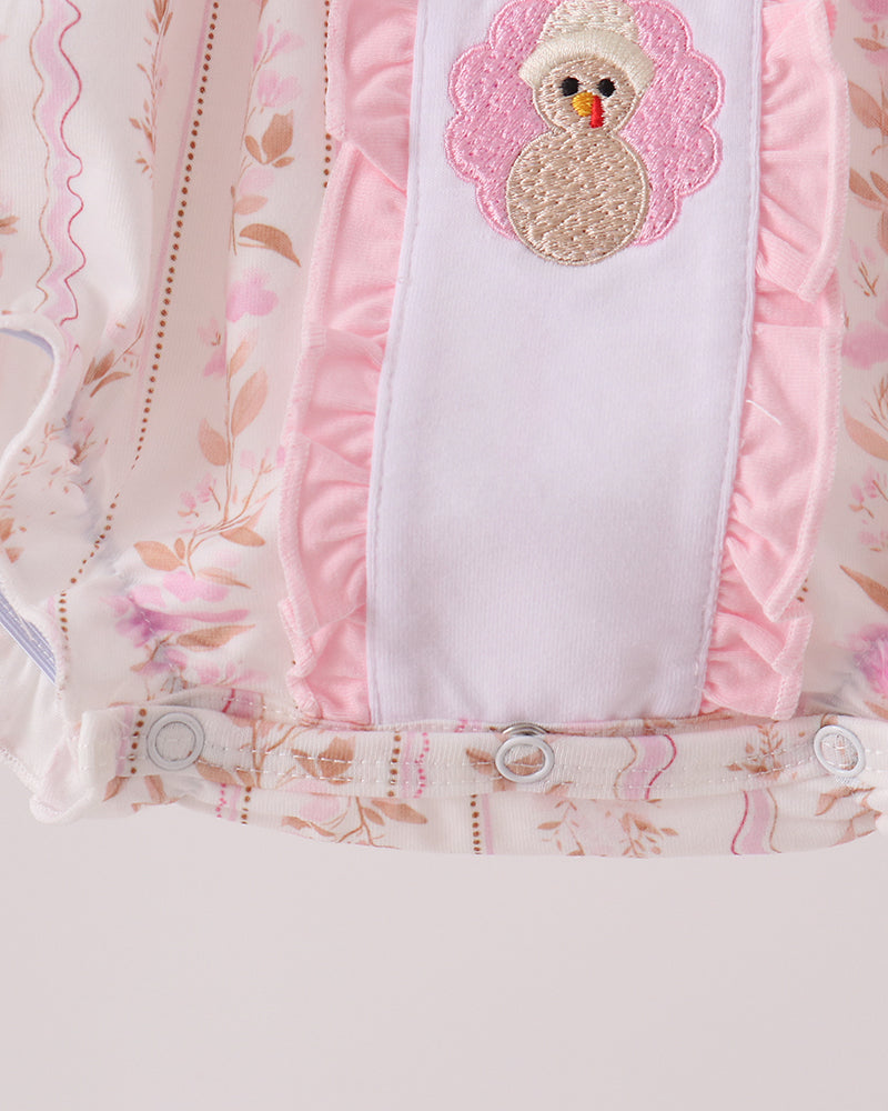 Pink bubble romper front panel with two embroidered turkey appliques and snap placket