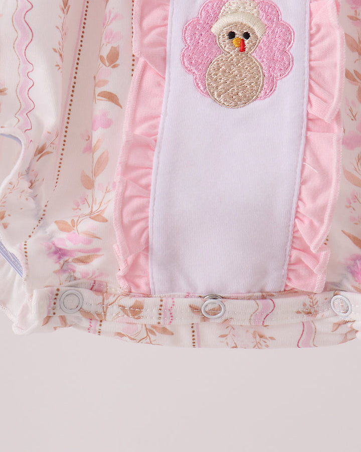 Pink bubble romper front panel with two embroidered turkey appliques and snap placket