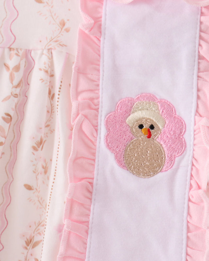Pink ruffle dress with embroidered turkey patch and scalloped trim