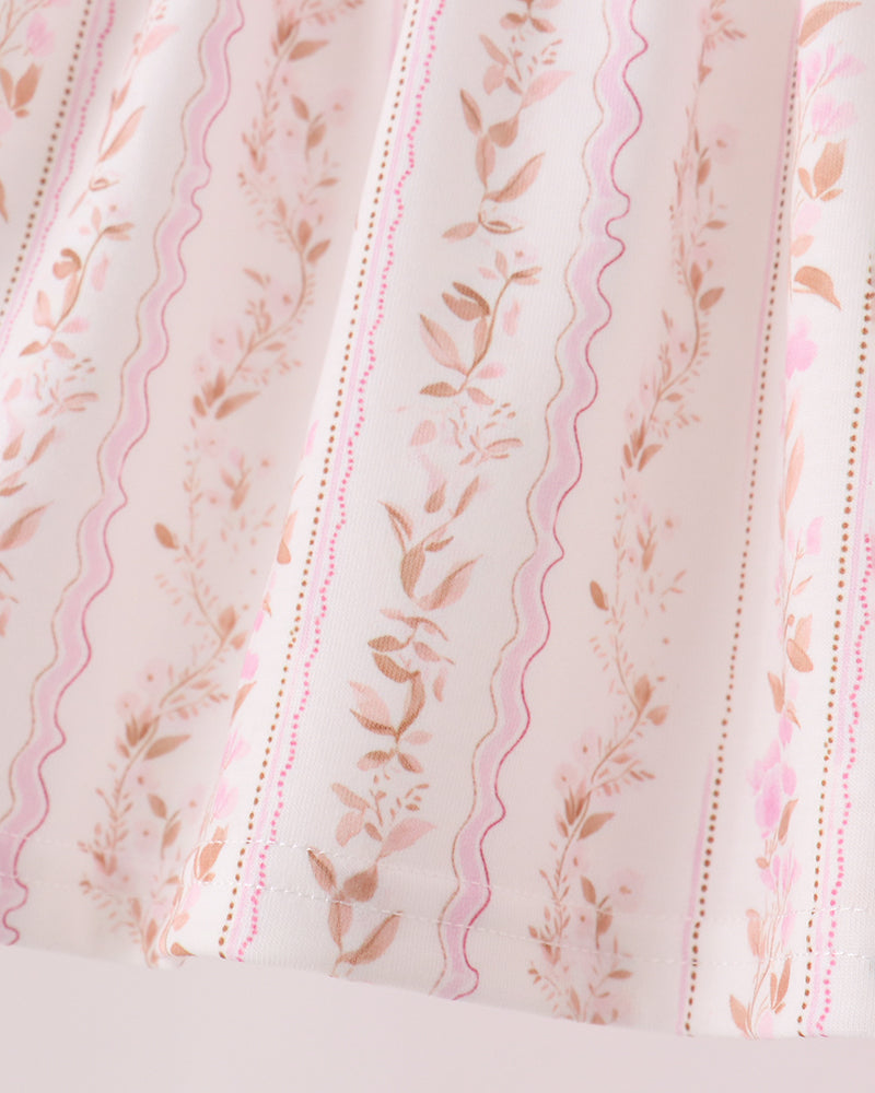 Pink floral ruffle top fabric with wavy embroidered stripes and small flowers