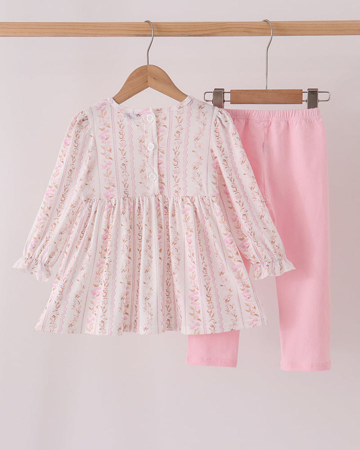 Pink floral embroidered ruffle top and matching pants set on hangers