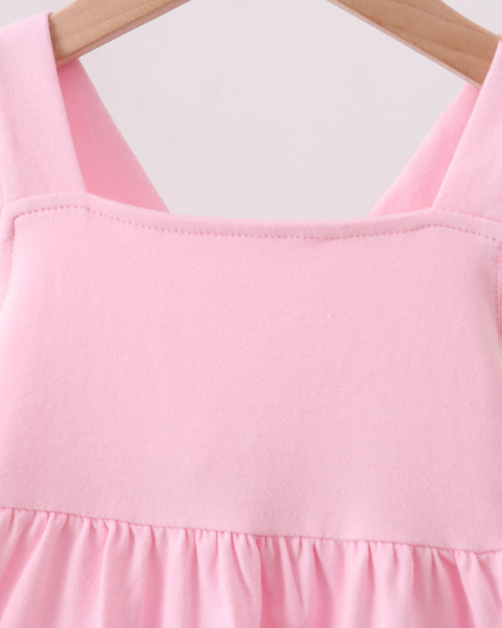 Pink sleeveless dress with ruffled neckline and gathered skirt