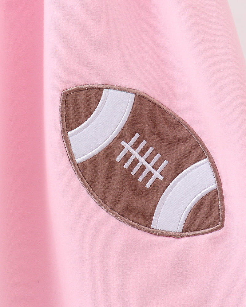 Pink dress with football applique patch on the front