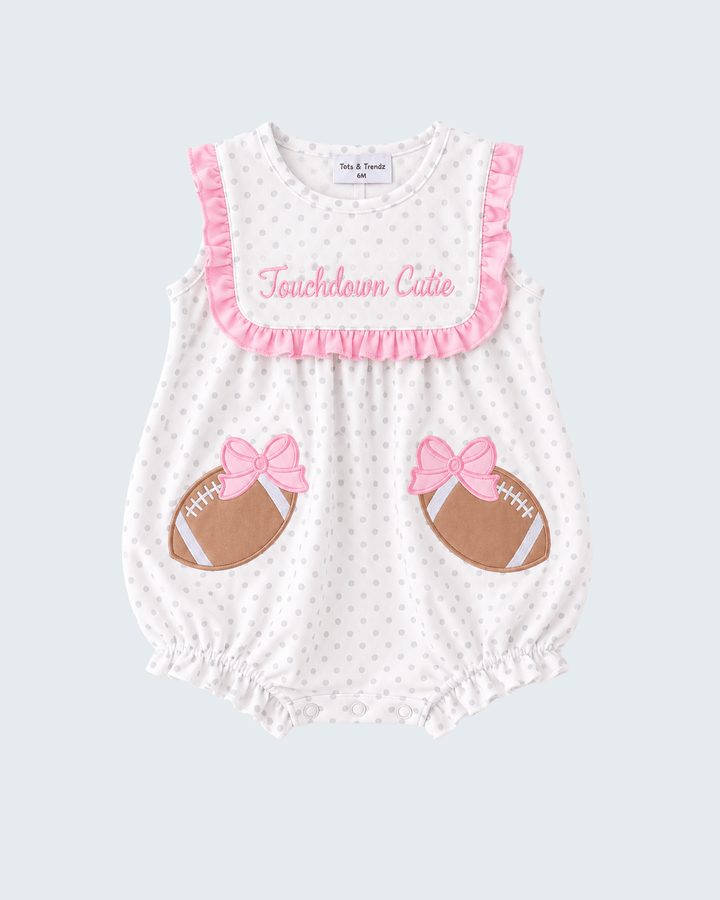 White polka-dot baby romper with pink ruffle trim, &