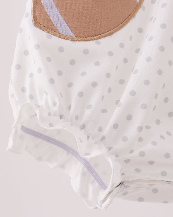 White polka-dot baby romper with football applique and ruffled leg opening