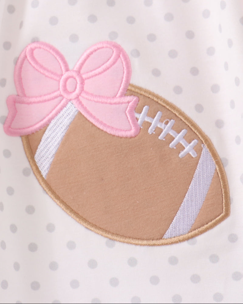 White dress with pink bow and football applique patch on polka-dot fabric