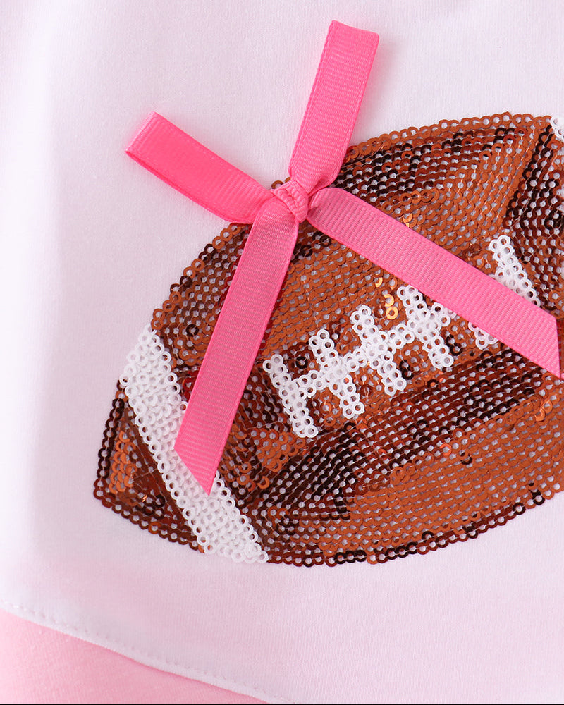 Pink sequin football skort set with white and black sequin heart panel and ribbon bow