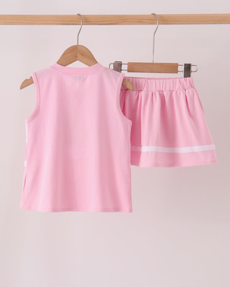Pink and white striped sleeveless top with matching ruffled skort set hanging on a rack