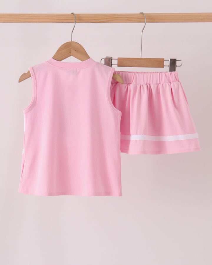 Pink and white striped sleeveless top with matching ruffled skort set hanging on a rack
