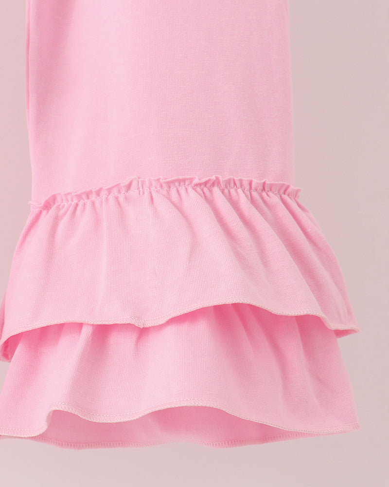Pink ruffle hem top and tiered ruffle waist pants set in solid pink