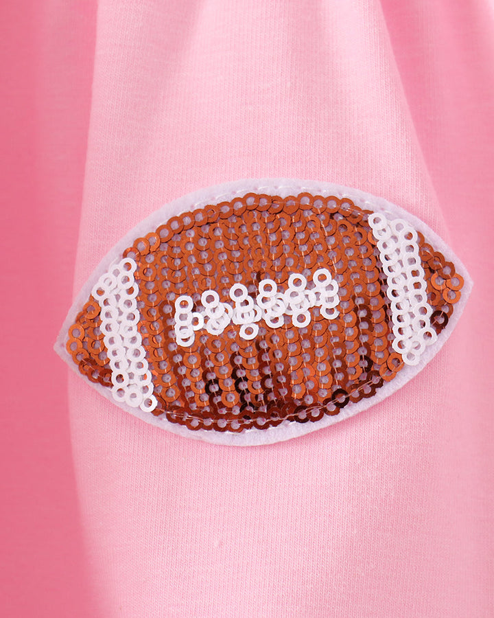 Pink dress bodice with large football-themed sequin patch with white edge