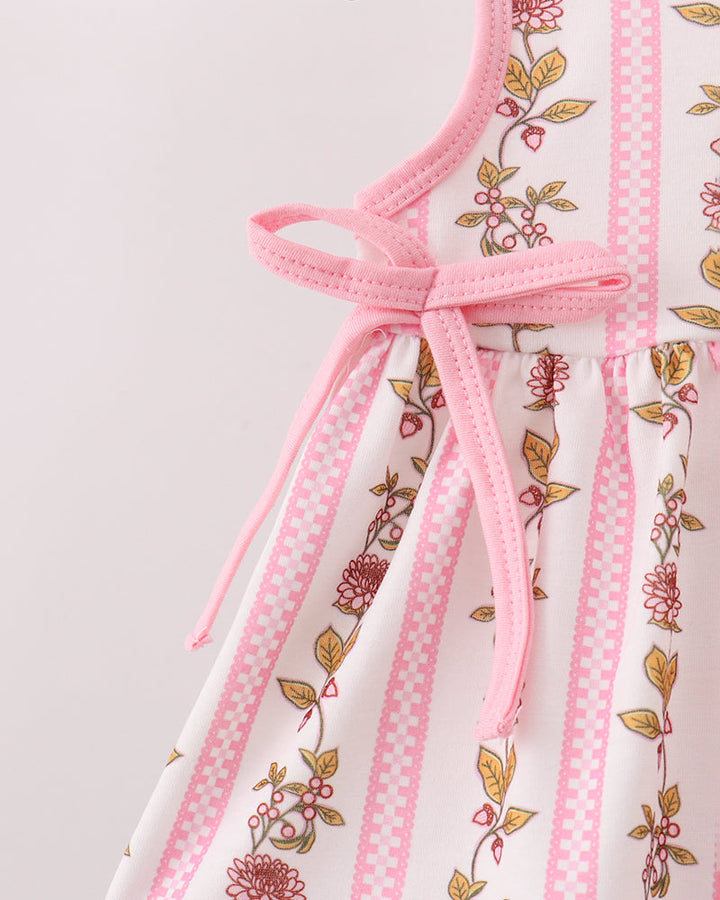 Floral dress with pink straps on a light gray background