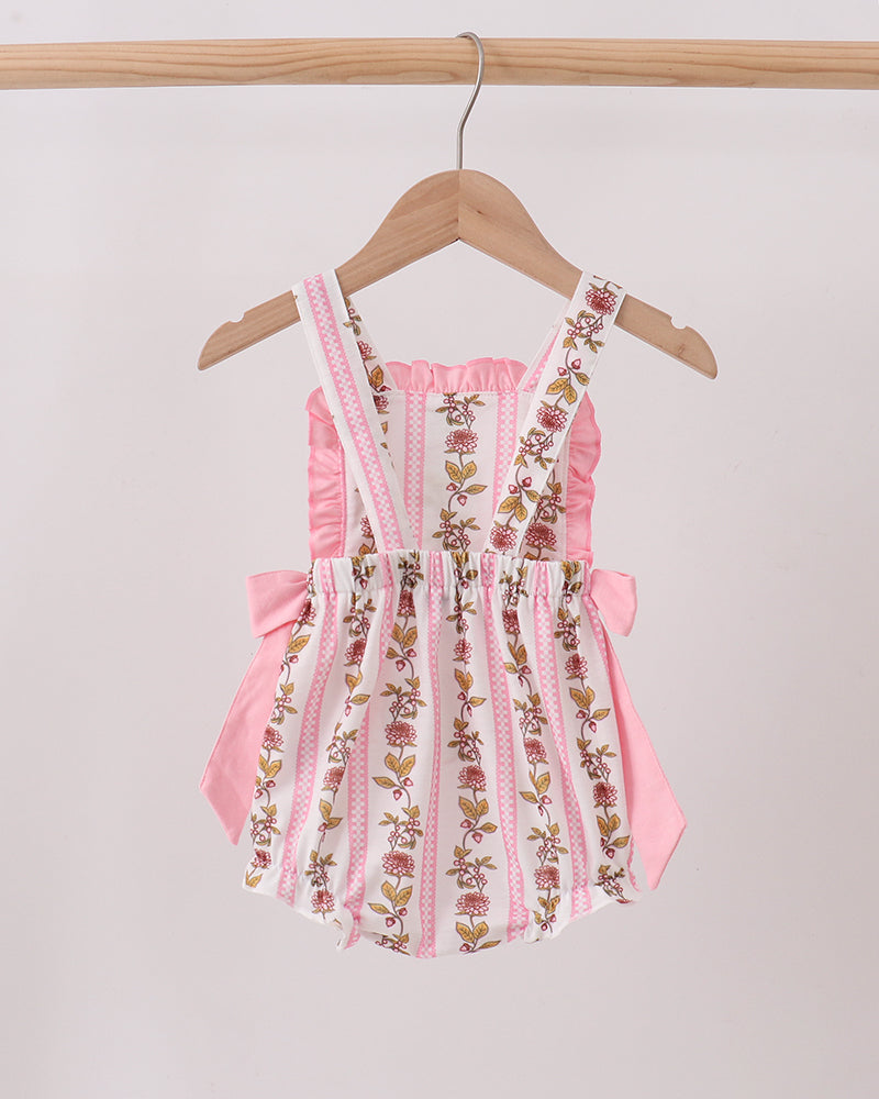 Pink floral embroidered romper on a hanger against a light background