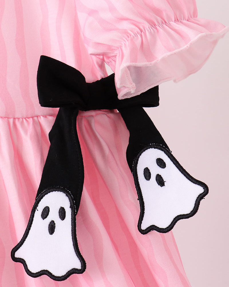 Pink dress close-up with black ghost appliques and ruffle puff sleeves
