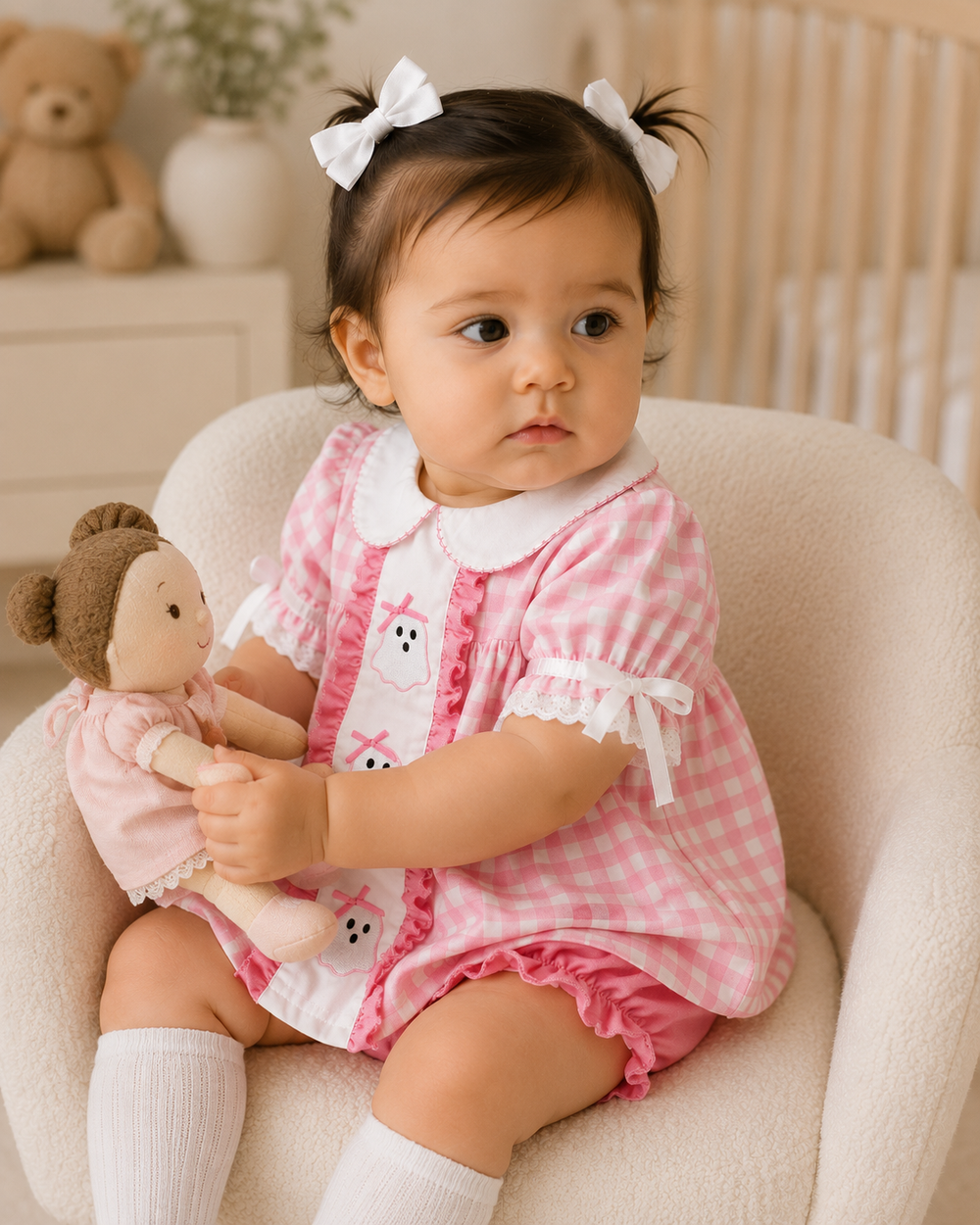 Baby girl wearing pink gingham ghost-embroidered dress with white collar and pink bloomers