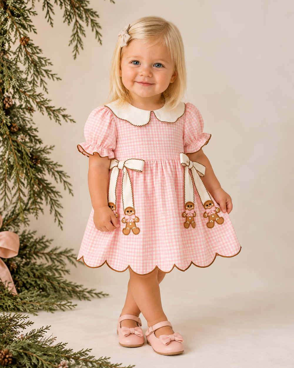 Pink gingham toddler dress with scalloped hem, short sleeves, Peter Pan collar, gingerbread bows