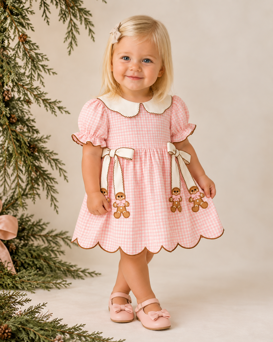 Pink gingham toddler dress with scalloped hem, short sleeves, Peter Pan collar, gingerbread bows