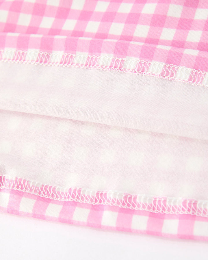 Girls pink gingham dress hem with ruffled elastic trim and gathered stitching
