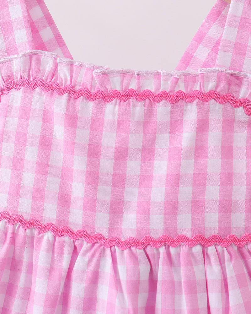 Pink and white checkered dress with lace trim on a hanger