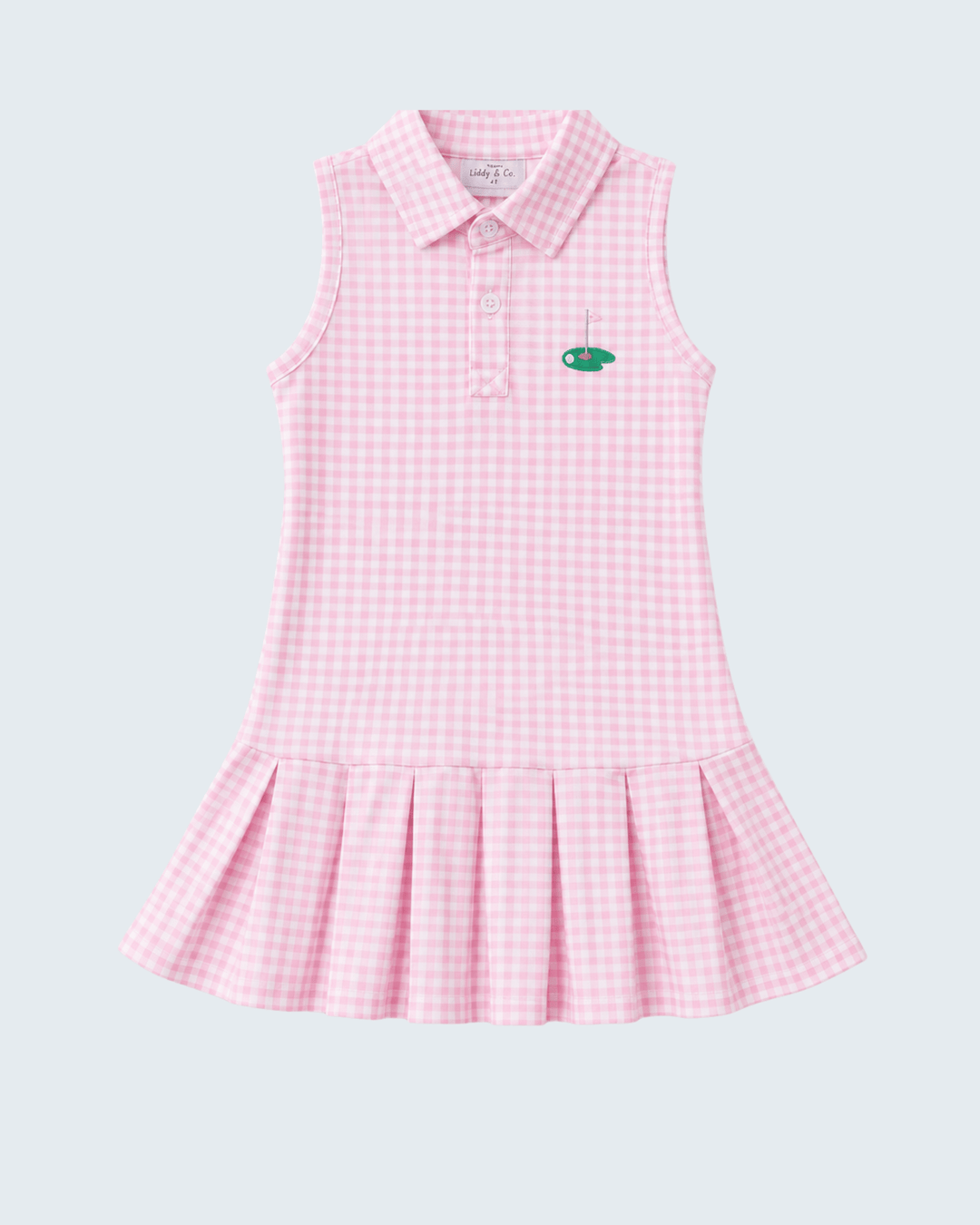 A sleeveless pink and white gingham polo dress for girls, featuring a small green embroidered fish logo on the left chest, set against a solid light gray background.