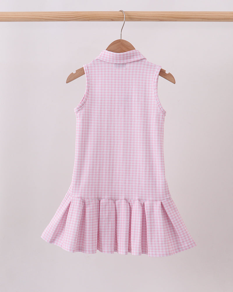 Pink gingham sleeveless golf dress with button placket and tiered ruffle skirt