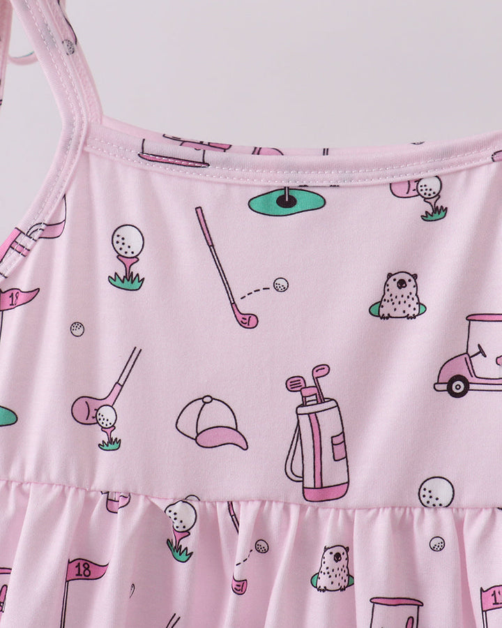 Pink dress with golf-themed pattern on a white background
