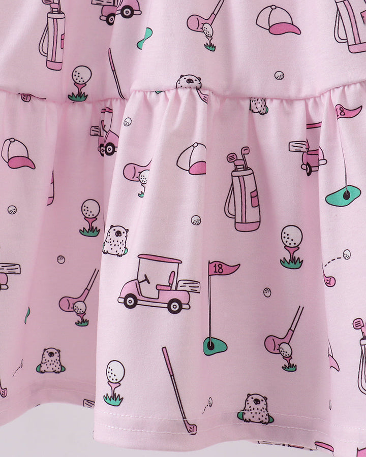 Pink dress with golf-themed pattern on a white background