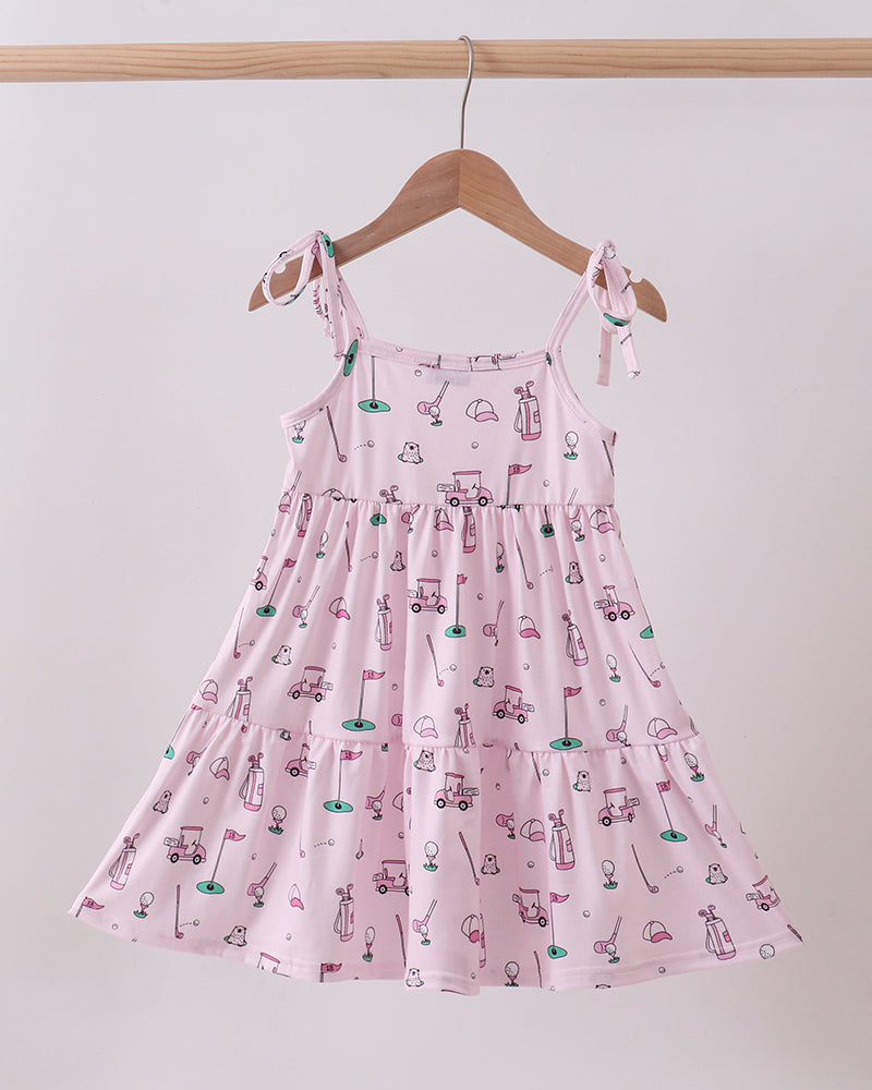 Pink dress with car pattern on a hanger against a white background