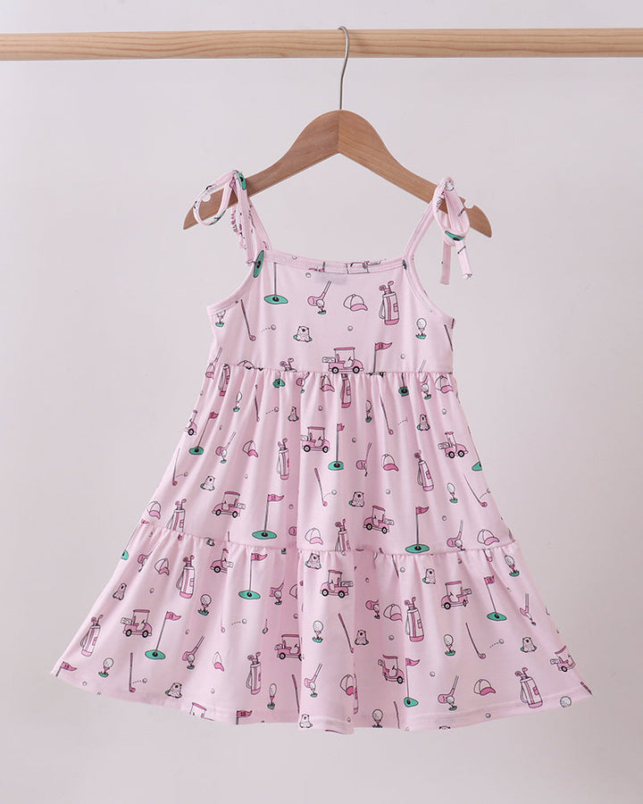 Pink dress with car pattern on a hanger against a white background