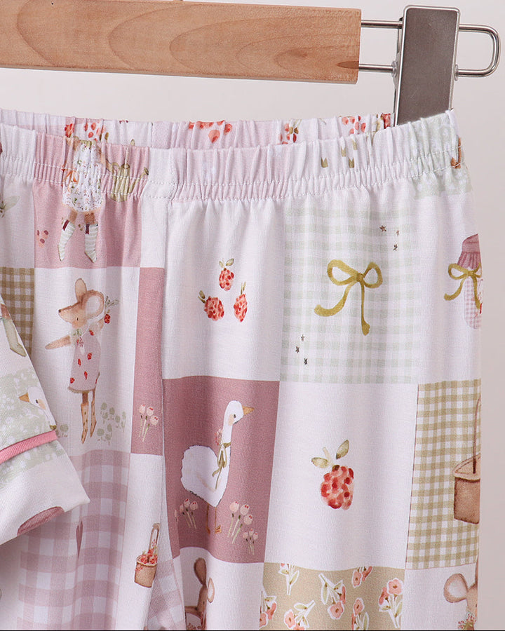 Pink and white checkered pajama pants with elastic waist and patchwork panels