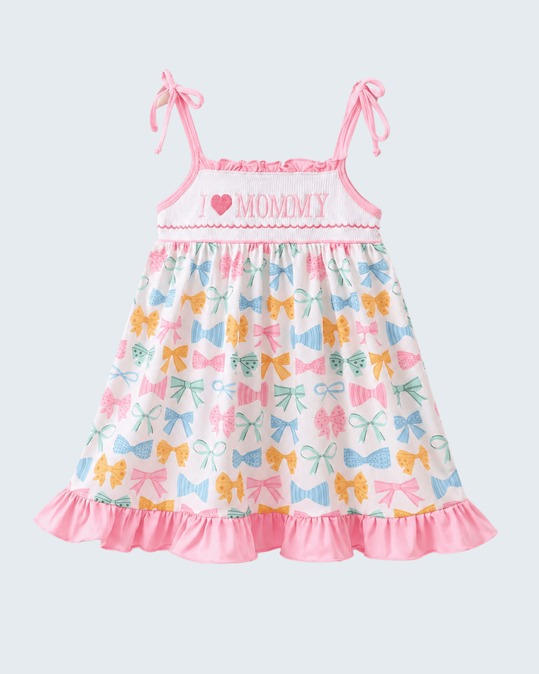 Children's dress with bow pattern and 'Mommy' text on a light gray background