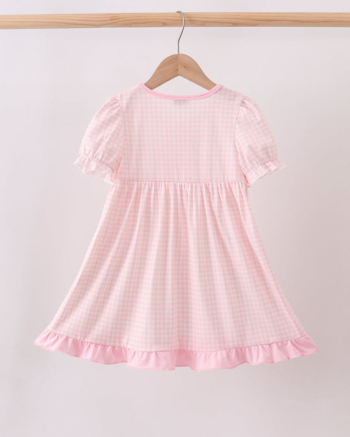 Pink gingham dress with puff sleeves and a ruffled hem
